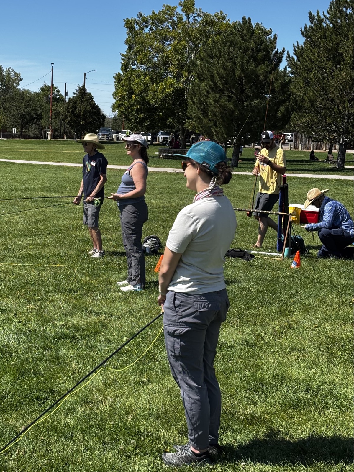 Participants practicing fly casting on the lawn at Fort Marcy Park